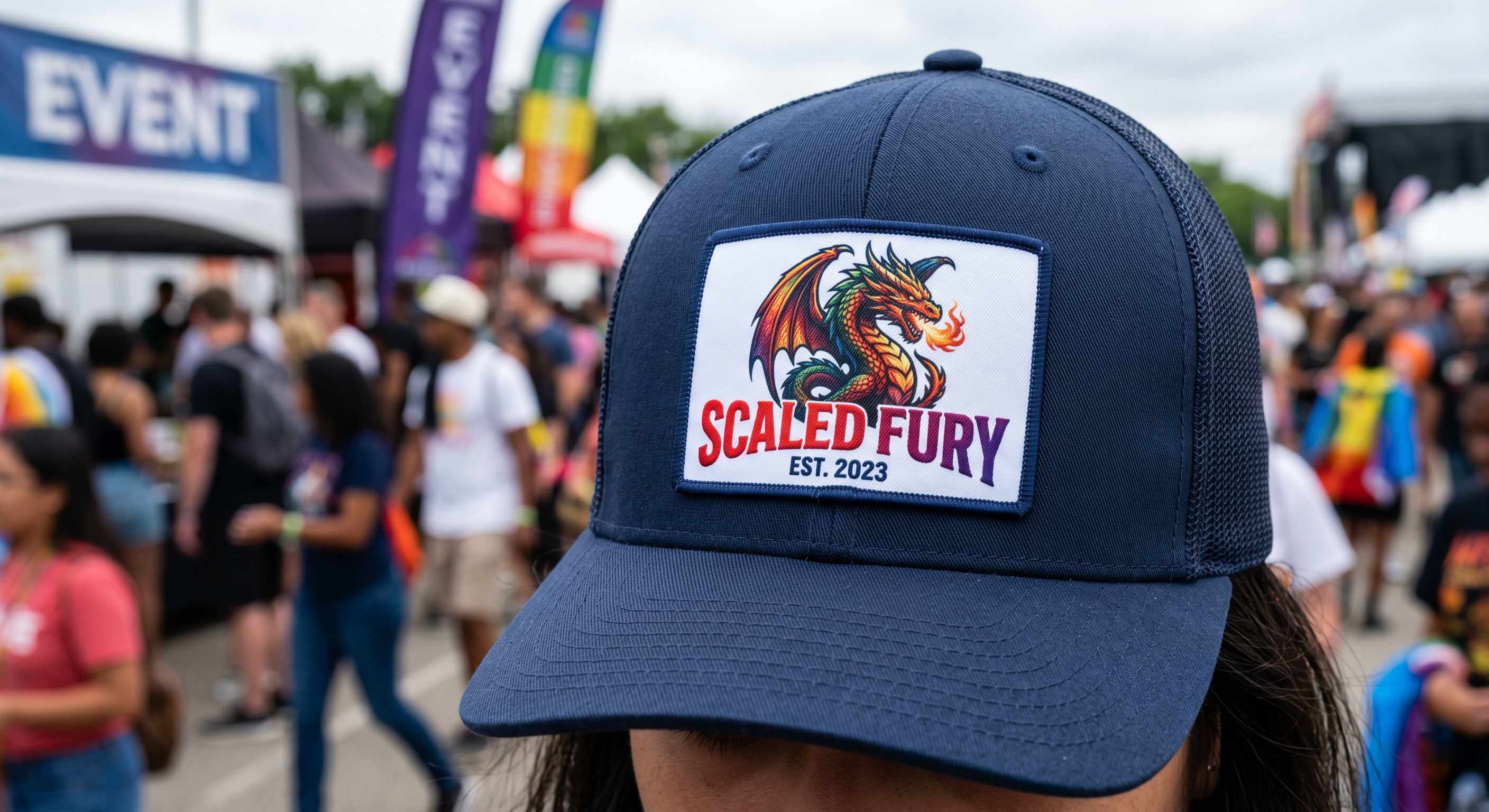 Close-up of black trucker hat with detailed sublimated dragon patch, showcasing gradients